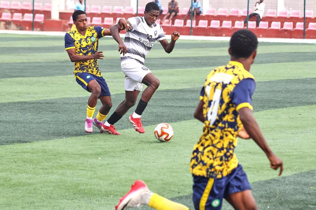 Footballers competing for the ball during a match